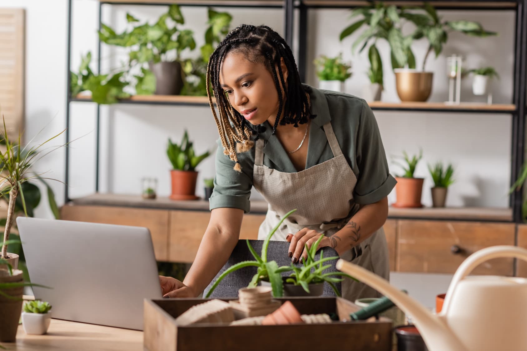 Florist checking orders on a laptop in her shop