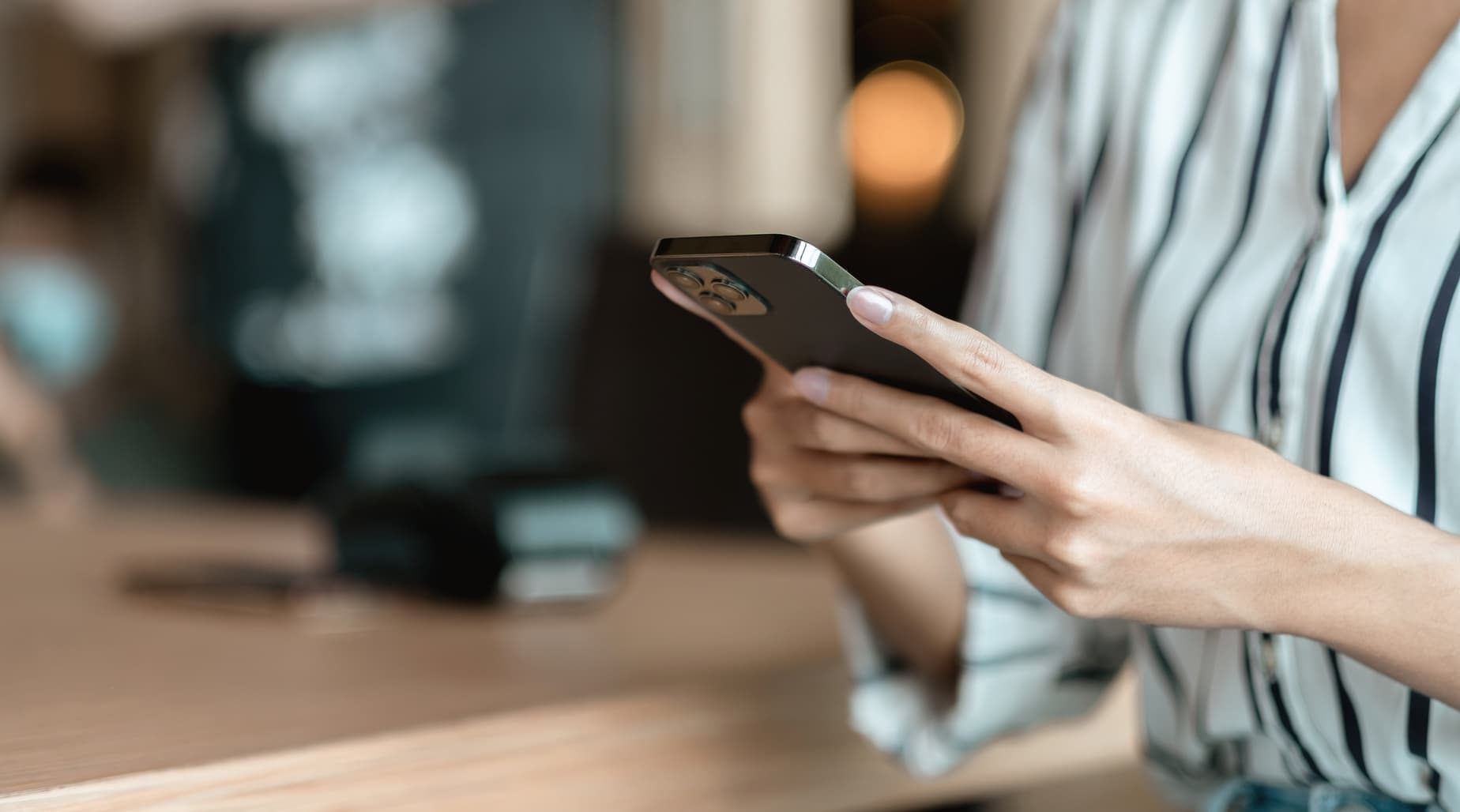 Person using a mobile app at a cafe